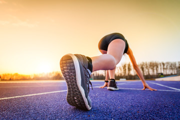 Poster - Back view of feet running woman starting from start line on racetrack