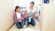 © Кирилл Рыжов - Happy young mother doing laundry with her teenager daughter at home