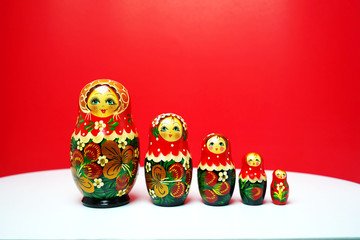 Matryoshka traditional Russian wooden dolls;Russian souvenir Matrioshka ;Nesting dolls on red background bring in lucky and wealthy.