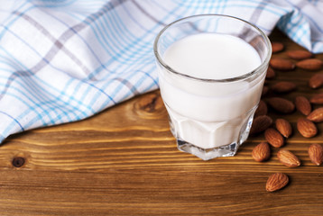 Poster - glass of milk, a number of almonds and a napkin