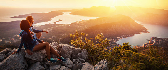 happy couple watching the sunset in the mountains