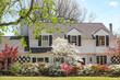 © Susan Vineyard  - Traditional upscale home with dogwood tree and azelea bushes - beautifully landscaped in springtime