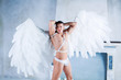 male model with big white angel wings