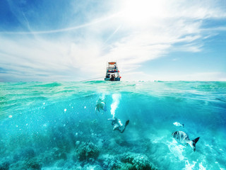 divers and boat in the caribbean sea