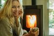 © PhotoAlto - Mature woman relaxing with coffee at home, portrait