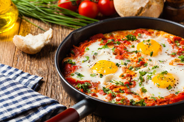 Shakshouka, dish of eggs poached in a sauce of tomatoes, chili peppers, onions