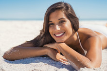 Smiling Woman Lying On Sand