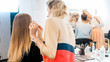 © Kyrylo Ryzhov - Rear view image of professional makeup artist working with model