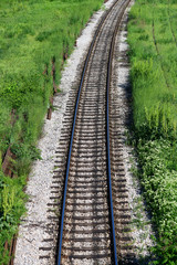 Wall Mural - Railroad and green grass. Train rails 