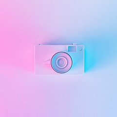 Wall Mural - Vintage camera in vibrant bold gradient purple and blue holographic colors. Concept art. Minimal summer surrealism.