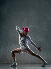 Young beautiful male dancer posing in studio