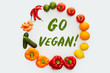 © LIGHTFIELD STUDIOS - top view of circle of vegetables and fruits with text Go Vegan isolated on white