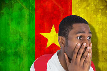 Sticker - Nervous football fan looking ahead against cameroon flag in grunge effect