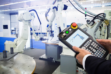 Poster - Engineer with teach pendant device. Programming robot with robotic arm. Smart factory 