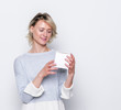 © PaulShlykov - Close up shot of female holding a small gift box. Small gift in the hands of a woman indoor.