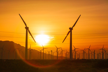 Silhouetted Wind Turbines Over Dramatic Sunset Sky