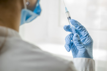 Wall Mural - Syringe for injection in the hands of a doctor. Vaccine.