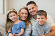 © WavebreakmediaMicro - Parents and children sitting on sofa