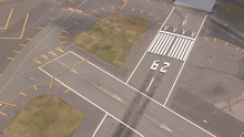 AERIAL: Pavement Surface And Flight Markings On Empty Runway Field On Airport
