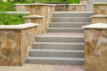 Wall Mural - steps of marble and granite surrounded by natural stone plates in a recreation park