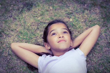 Wall Mural - Relaxing little girl with head in the clouds