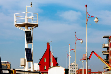 beacon sky solar panels top light transformation energy blue white sun saving beam two house red sity Infrastructure lantern