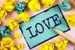 Text sign showing Love. Conceptual photo Intense feeling Deep affection Romantic Sexual attachment Relationship written on Sticky Note paper within Paper Balls on plain background Pencil.