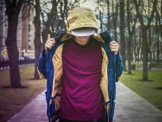 Wall Mural - urban fashion concept, young man in snapback and jacket outside