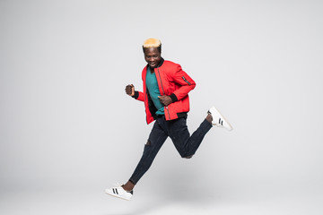 Wall Mural - Young handsome afro american man jumping over isolated white background.