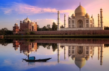 Fototapete - Taj Mahal Agra at sunset with wooden boat on river Yamuna.