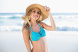 © WavebreakmediaMicro - Cheerful sexy blonde in bikini wearing straw hat