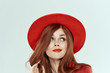 pretty woman in red hat looks away
