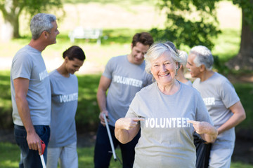 Canvas Print - Happy volunteer grandmother with thumbs up 