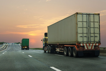 Truck on highway road with container, transportation concept.,import,export logistic industrial Transporting Land transport on the asphalt expressway with sunrise sky