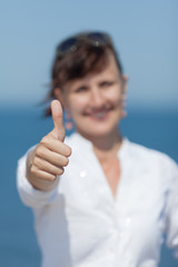 Wall Mural - Middle aged woman showing thumb up