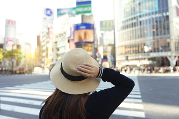 Woman is crossing the road at Shibuya junction in Tokyo, Japan.