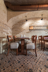 Poster - Interior of vintage restaurant, tables ceiling and brick wall