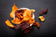 Food Concept Assort Of Vegetable Chips On Black Slate Plate