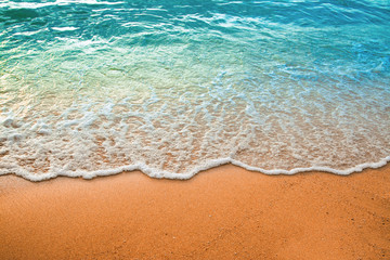 wave of blue ocean on sandy beach. background.