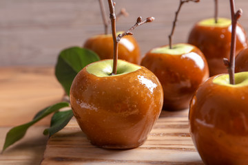 Delicious green caramel apples on table