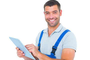 Poster - Portrait of happy repairman using digital tablet