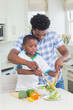 © WavebreakmediaMicro - Happy father and son preparing vegetables