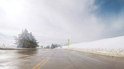 Wall Mural - Driving on suburban road after the Sping snow storm