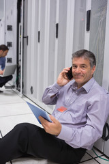 Aufkleber - Man phoning while doing maintenance and holding tablet