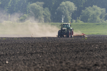 Tractor performs spring work in the field