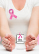 © vectorfusionart - Woman presenting breast cancer awareness message in her hands