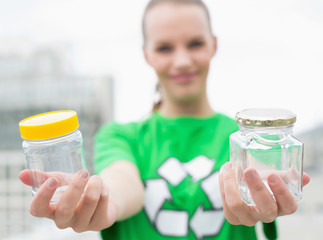 pleased pretty environmental activist offering two jars