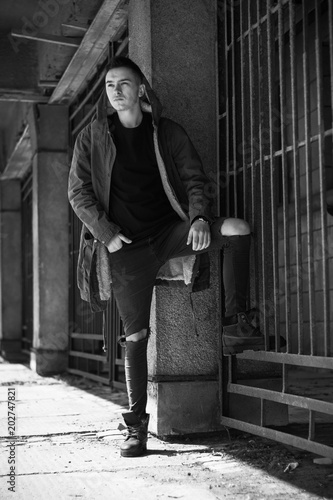 Pretty Serious Young Man On The Street Casual Lifestyle Clothes Male Model Posing Near Gates Sureness Guy In Monochrome Style Buy This Stock Photo And Explore Similar Images At Adobe Stock