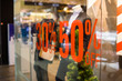 © Yulia - Shopping sale sign. Sign of sale shopping.discount sign on show window. Sale sign, symbol in clothes shop,The red announcement of a fifty-percentage discount on a glass show-window. Copy space