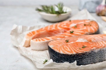 Fresh raw salmon steaks on table, closeup